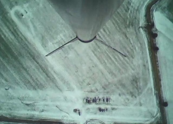 Looking down at our parked cars on the snow cover field from apogee